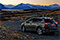 Image of a Toyota Rav4 at dusk overlooking a lake and mountains of the South Island